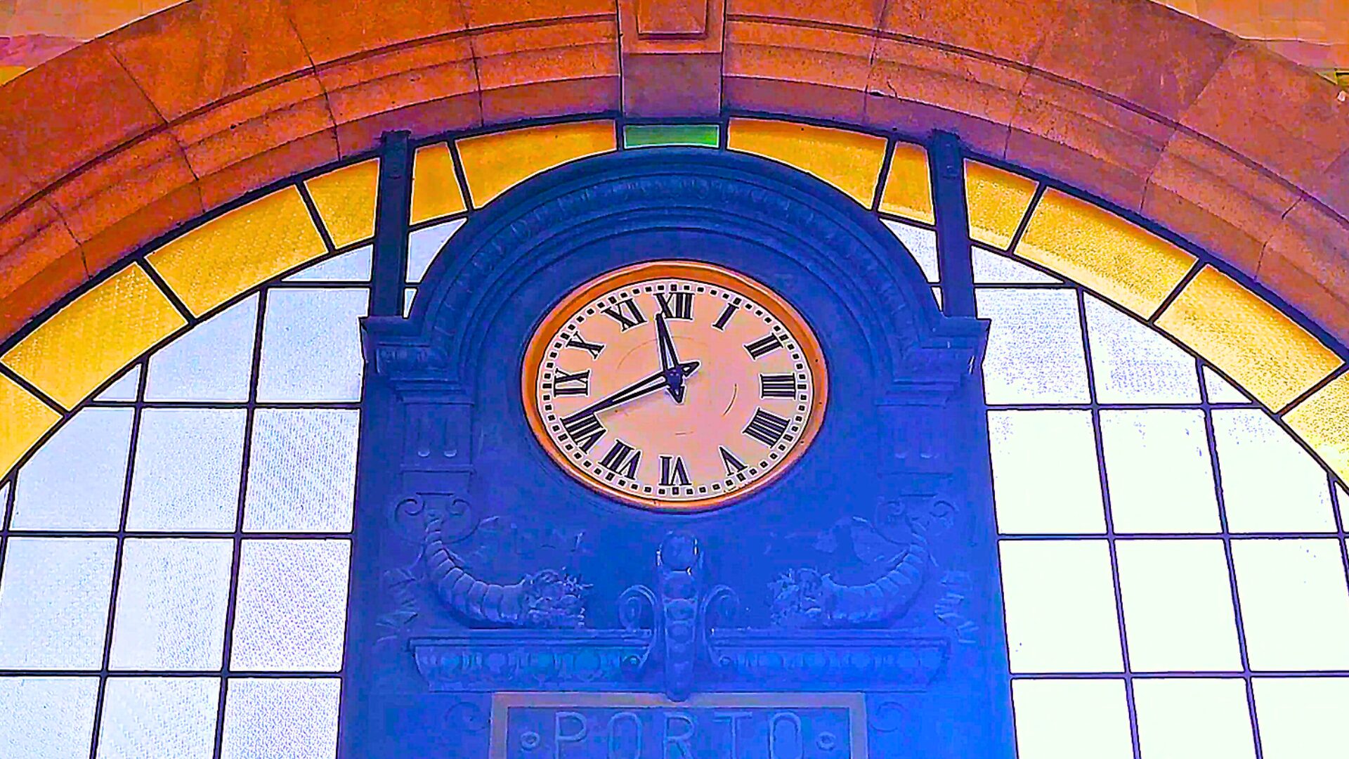 Clock and azulejo hall inside São Bento Station in Porto